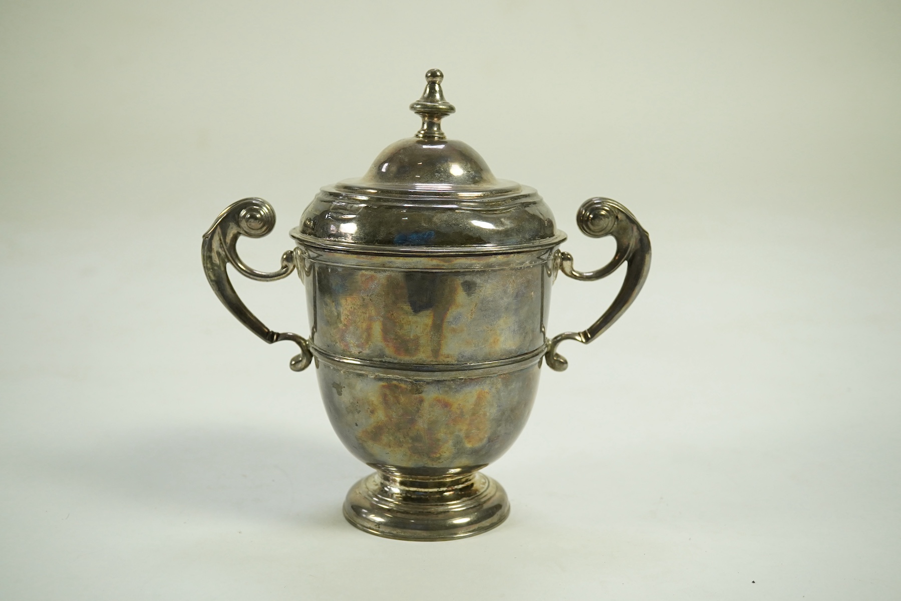 A George I Irish silver two handled cup by Philip Kinnersley, Dublin, 1719, with an earlier Queen Anne matched Irish silver cover by Joseph Walker, Dublin, 1704